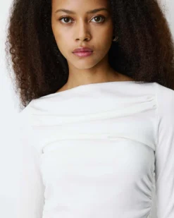 Top asymétrique manches longues bas en dentelle ivoire Bina
